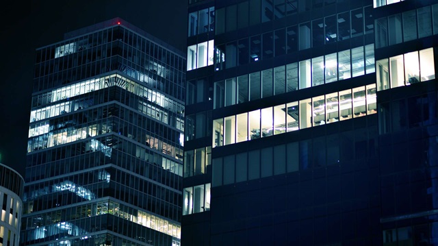 Office buildings windows illuminated at night