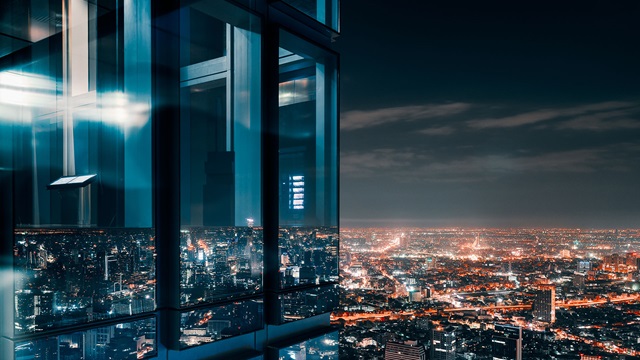 office building at night in bangkok with city skyline in background