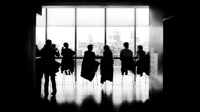 Group of people in black and white looking at the London skyline