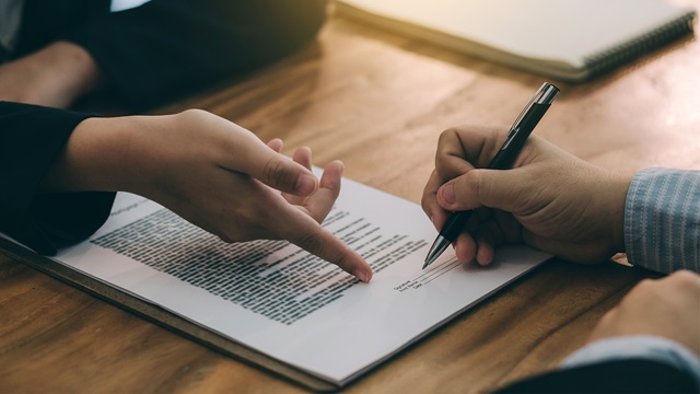 Signing the agreement in the contract.