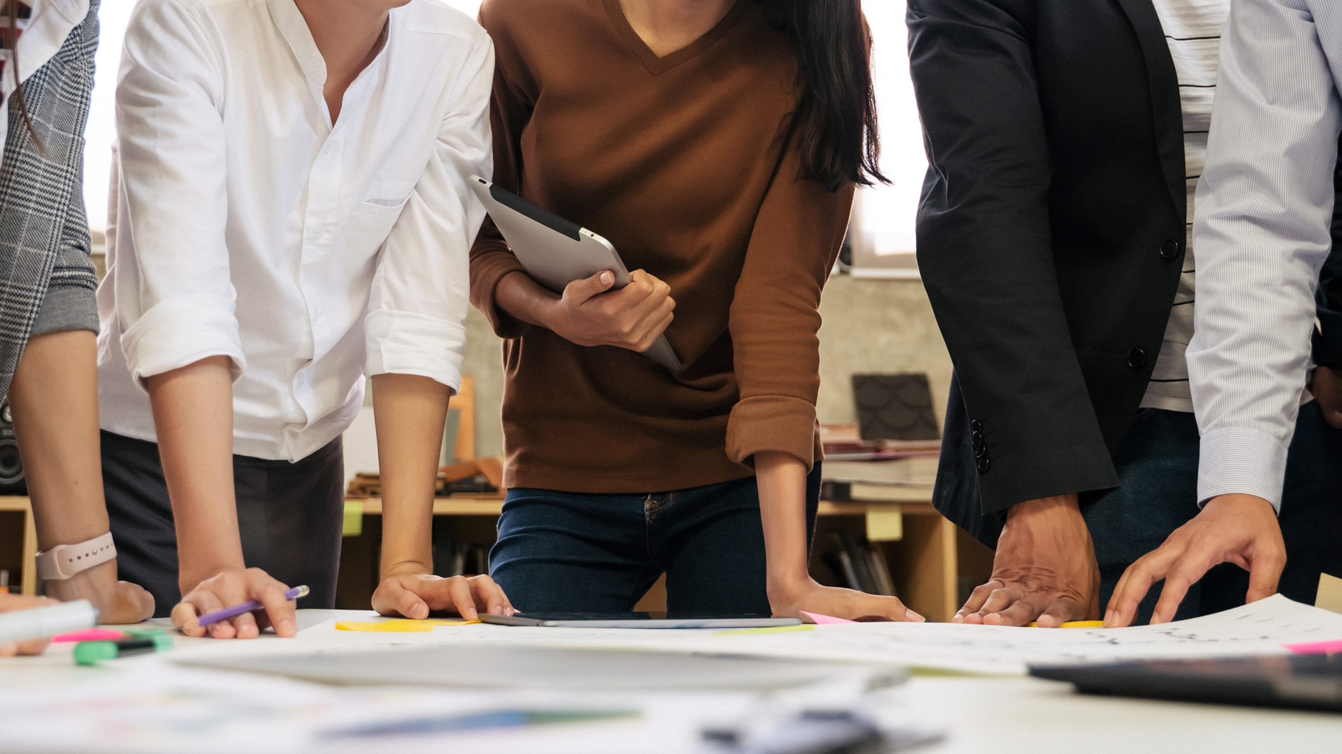 people leaning over a desk