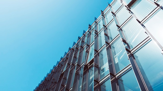 Corporate building with rectangular window designs with a blue sky in the background